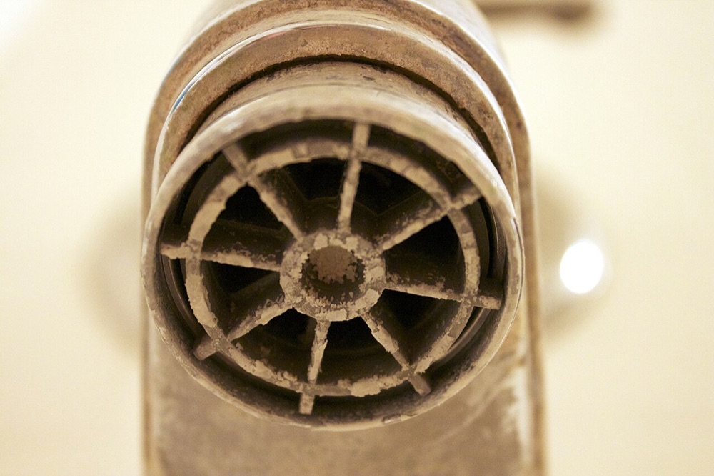 Hard-water mineral buildup on a fixture